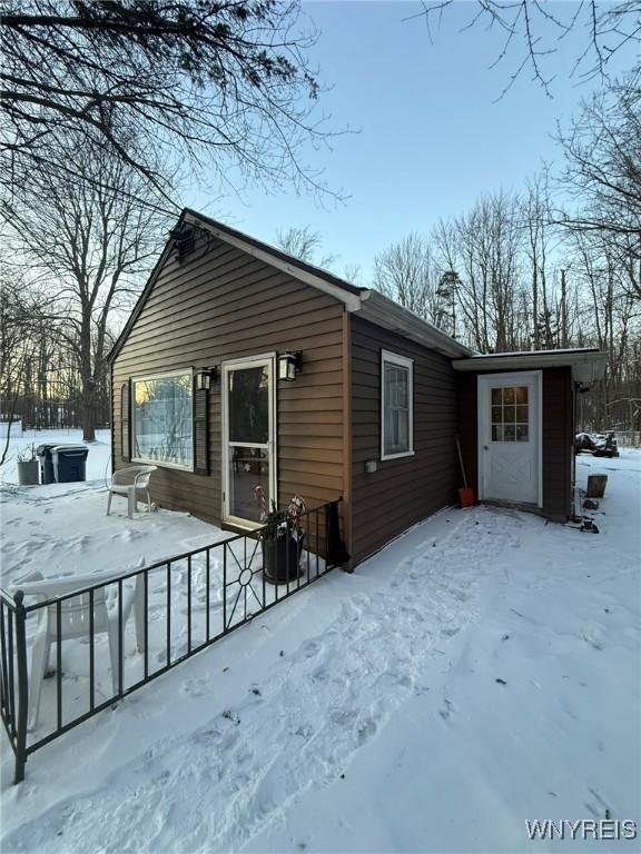 view of snow covered rear of property