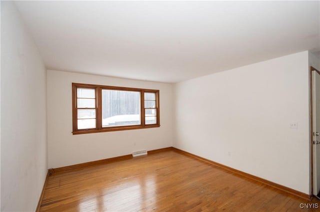 spare room with light hardwood / wood-style flooring