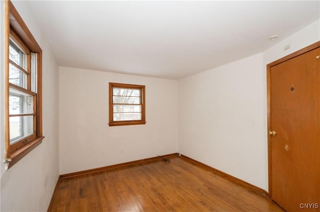 unfurnished room with wood-type flooring