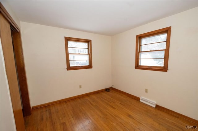 unfurnished bedroom featuring light hardwood / wood-style floors and a closet