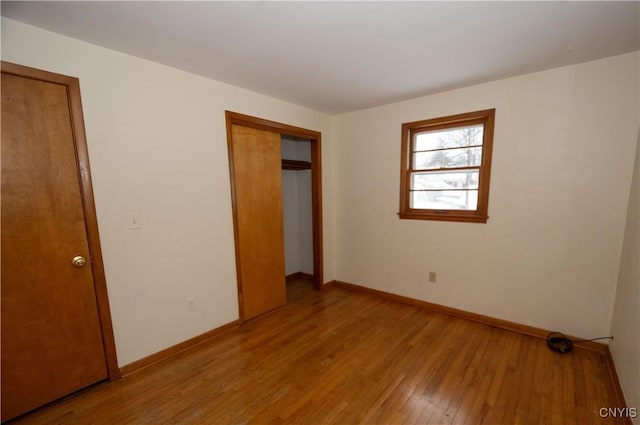 unfurnished bedroom with a closet and light hardwood / wood-style flooring