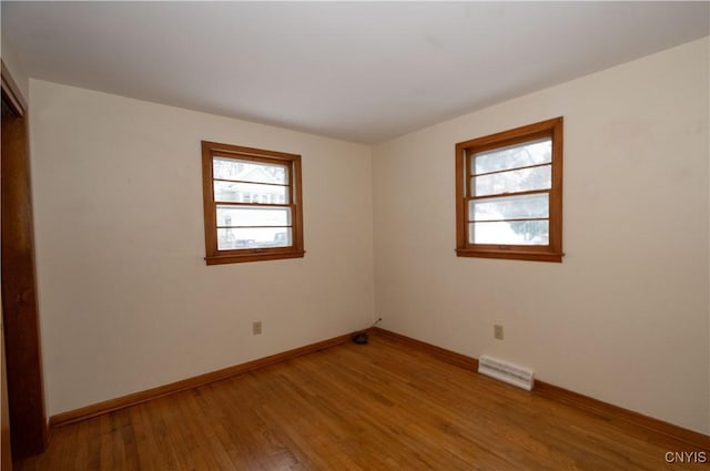 unfurnished room with light hardwood / wood-style floors