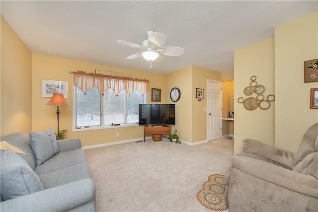 carpeted living room with a textured ceiling and ceiling fan