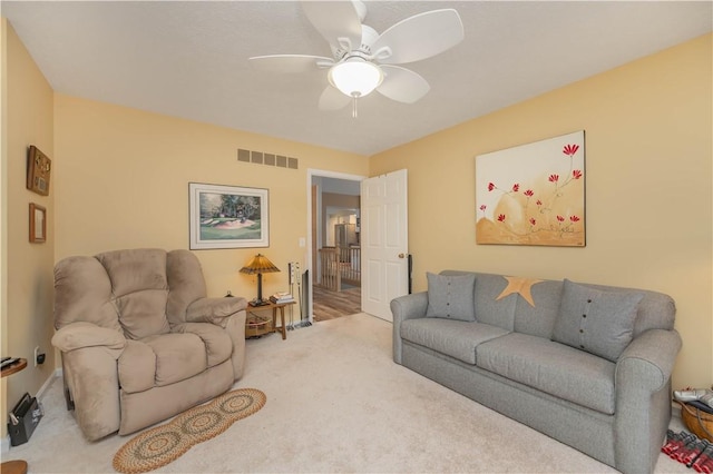 living room with carpet floors and ceiling fan