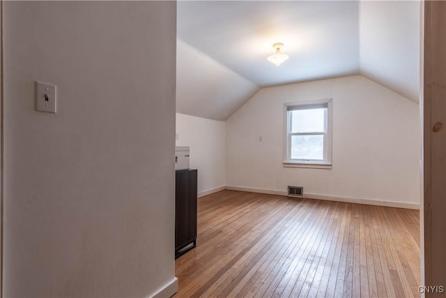 bonus room featuring light hardwood / wood-style flooring and lofted ceiling