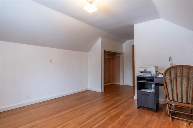 office space featuring light hardwood / wood-style flooring and vaulted ceiling