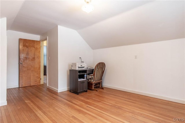 office area featuring vaulted ceiling and light hardwood / wood-style floors