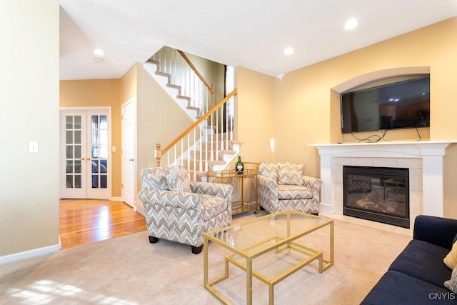 living room with french doors, a fireplace, and carpet