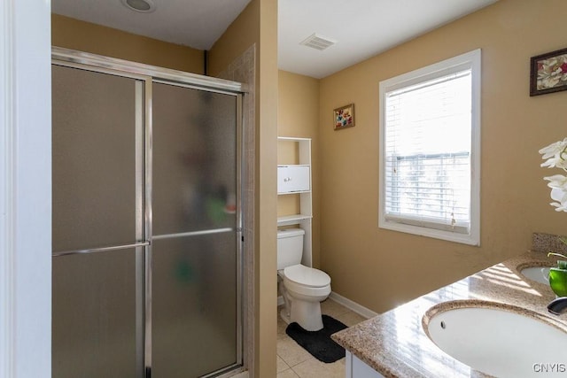 bathroom with tile patterned floors, vanity, toilet, and walk in shower