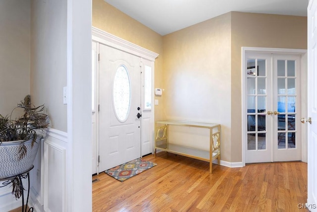 entrance foyer with light hardwood / wood-style flooring and french doors