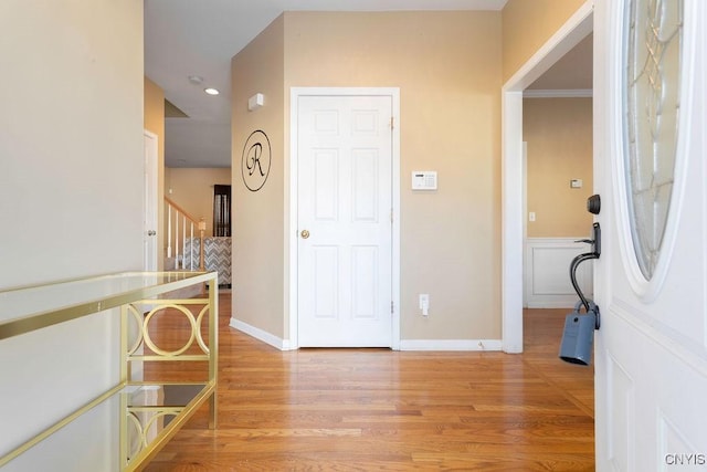 interior space featuring light hardwood / wood-style floors and ornamental molding