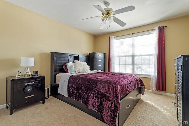 bedroom with ceiling fan, multiple windows, and light carpet