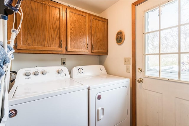 washroom with cabinets and washer and clothes dryer