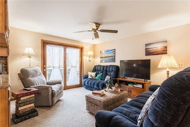 living room with ceiling fan and light colored carpet