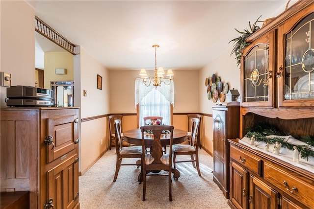 carpeted dining space with a notable chandelier