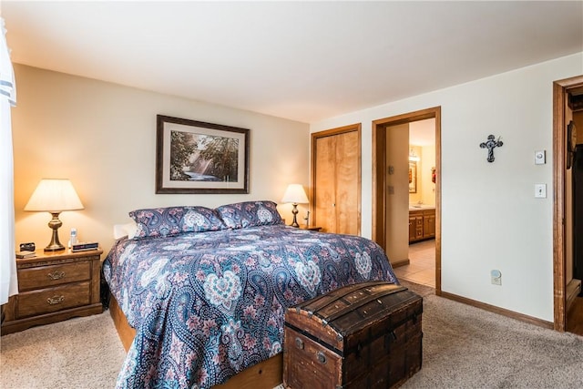 carpeted bedroom featuring a closet and ensuite bathroom