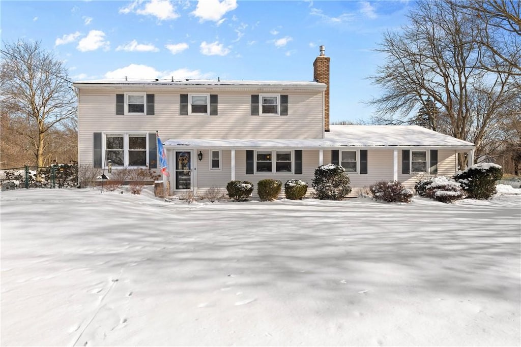 view of snow covered rear of property