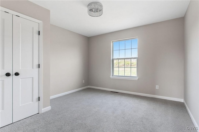 unfurnished bedroom with a closet and carpet flooring