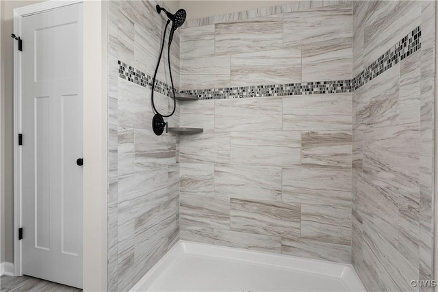 bathroom with a tile shower