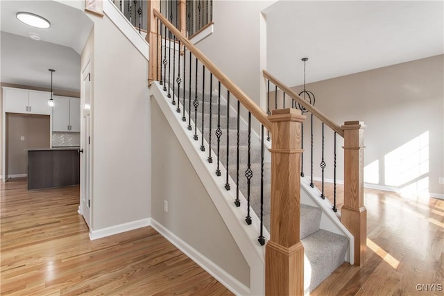 stairs featuring hardwood / wood-style floors