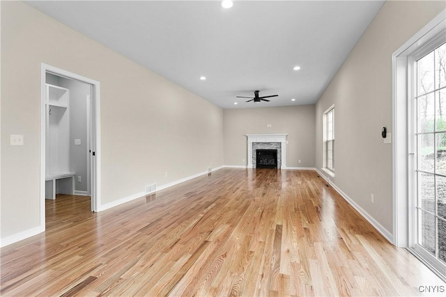 unfurnished living room with ceiling fan and light hardwood / wood-style flooring