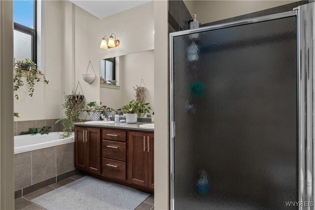 bathroom featuring vanity, tile patterned floors, and separate shower and tub