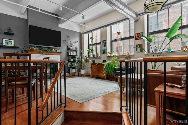 interior space with rail lighting and wood finished floors