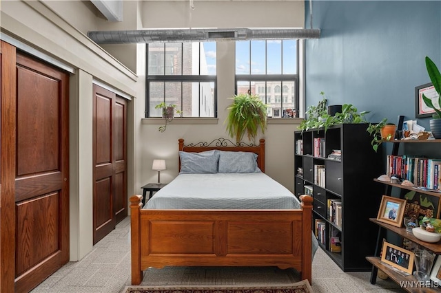 bedroom featuring light carpet