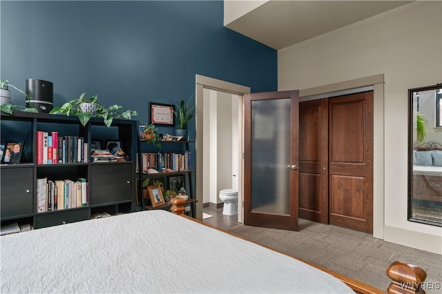 carpeted bedroom featuring connected bathroom