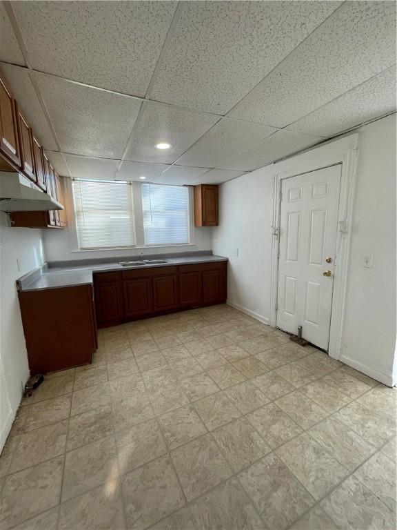 kitchen featuring sink and a drop ceiling