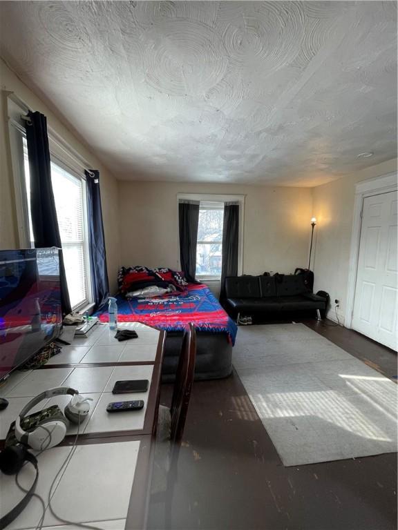 bedroom with multiple windows and a textured ceiling