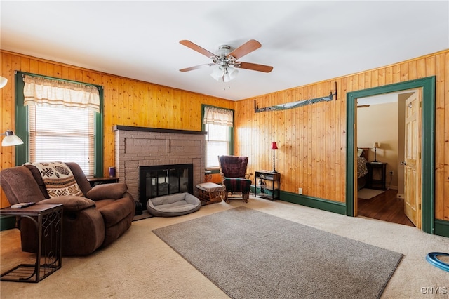 carpeted living room featuring a fireplace, plenty of natural light, and ceiling fan