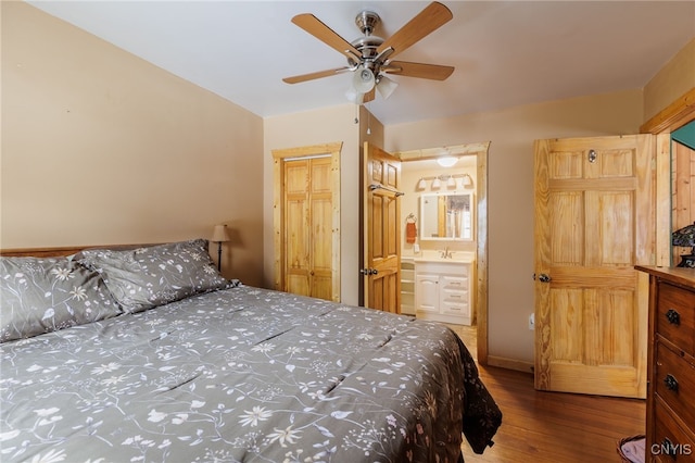 bedroom with ensuite bath, hardwood / wood-style flooring, sink, a closet, and ceiling fan