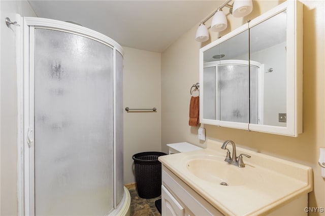 bathroom with walk in shower and vanity