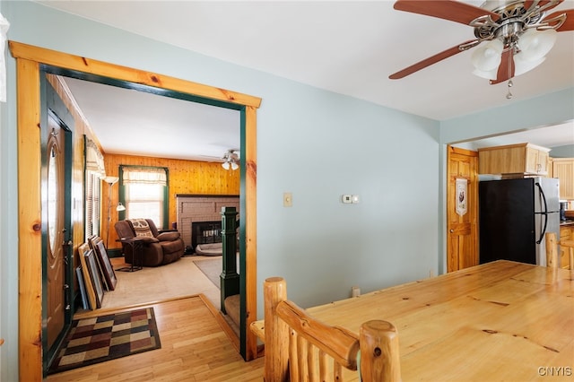 interior space with a fireplace, light hardwood / wood-style flooring, and ceiling fan