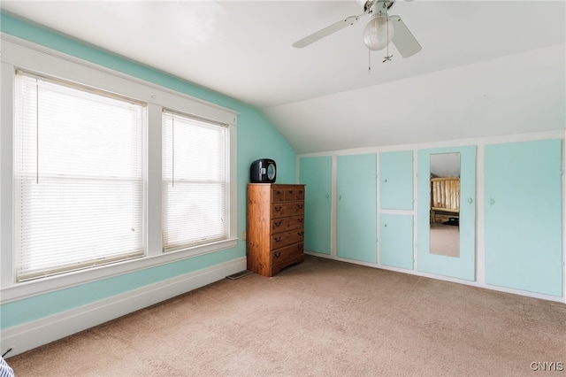 additional living space featuring ceiling fan, light carpet, and vaulted ceiling