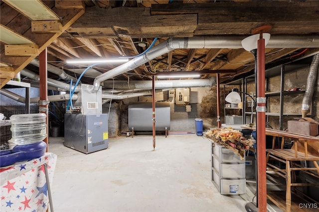 basement featuring electric panel and heating unit