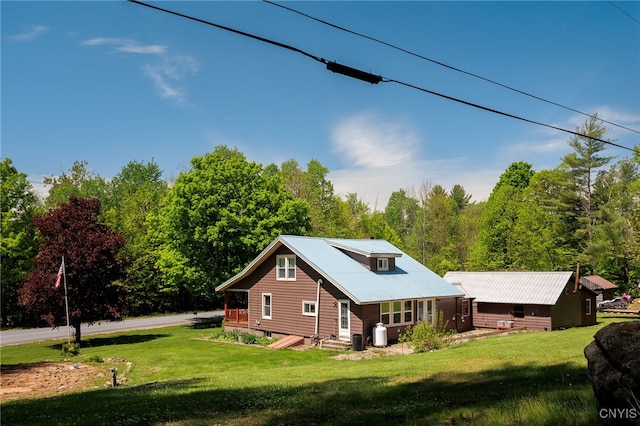 view of side of home with a yard