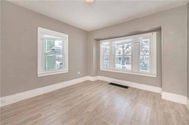 spare room with light wood-type flooring