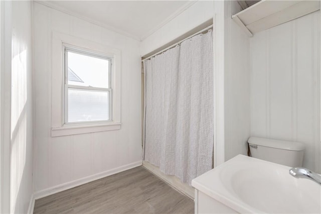 bathroom with wood-type flooring, toilet, vanity, and ornamental molding