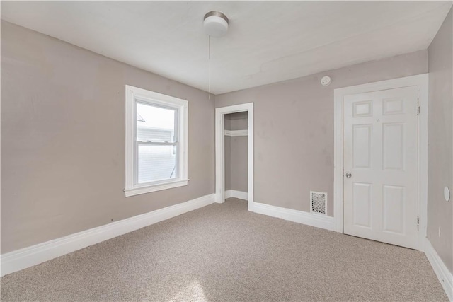 unfurnished bedroom with carpet flooring and a closet