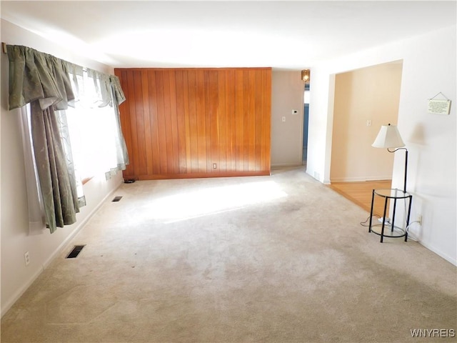 spare room featuring light colored carpet