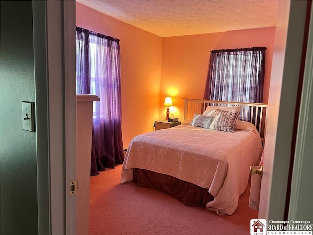 bedroom with carpet flooring and a textured ceiling