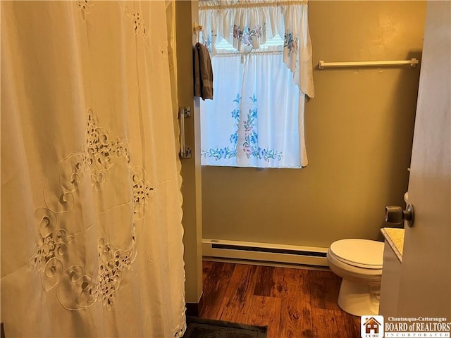 bathroom with a baseboard radiator, toilet, vanity, wood finished floors, and a shower with curtain