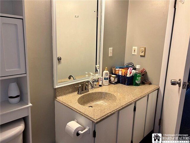 bathroom featuring toilet and vanity