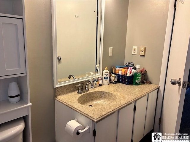 bathroom featuring vanity and toilet