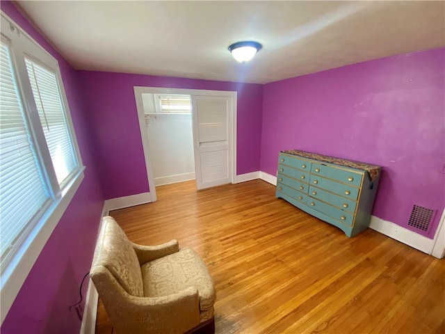 living area featuring light hardwood / wood-style floors and plenty of natural light