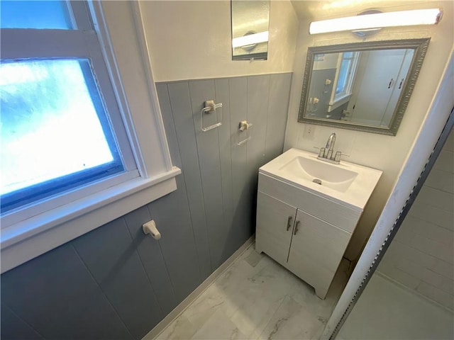 bathroom with wood walls and vanity