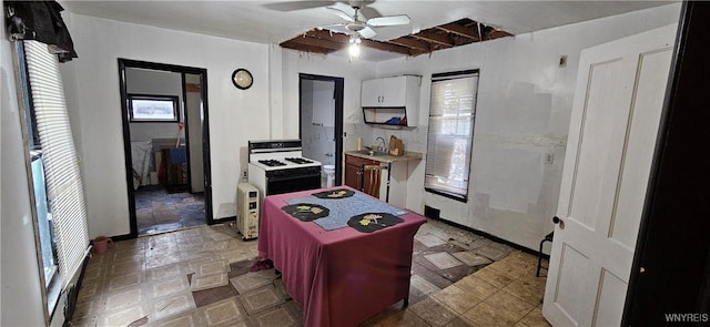 147 Montana Ave, Buffalo, NY 14211 - kitchen with a ceiling fan, plenty of natural light, white cabinetry, and white gas stove