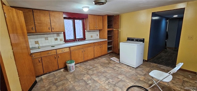 147 Montana Ave, Buffalo, NY 14211 - kitchen featuring light countertops, brown cabinetry, and washer / clothes dryer